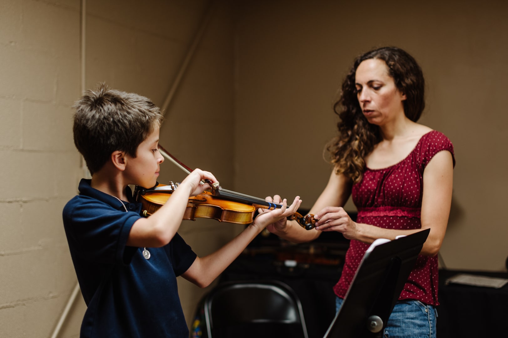 violin teacher instructing a student